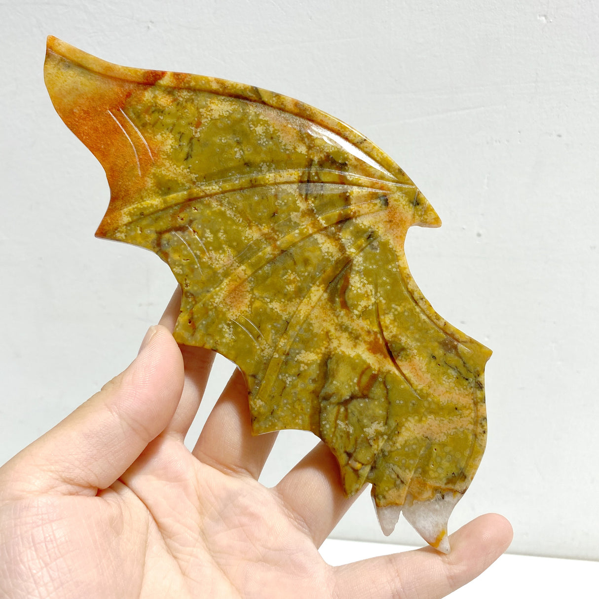 Yellow Ocean Jasper Demon And Angel Wing Carving With Stand